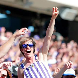 Student fan in striped overalls